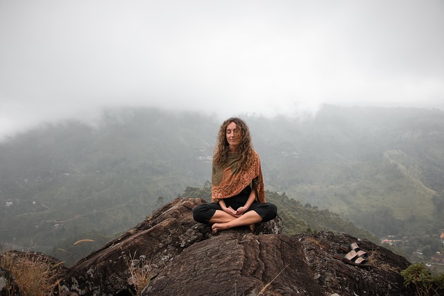 woman meditating on mountain